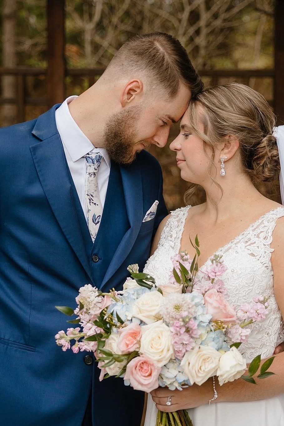 Couple with a soft pastel wedding bouquet