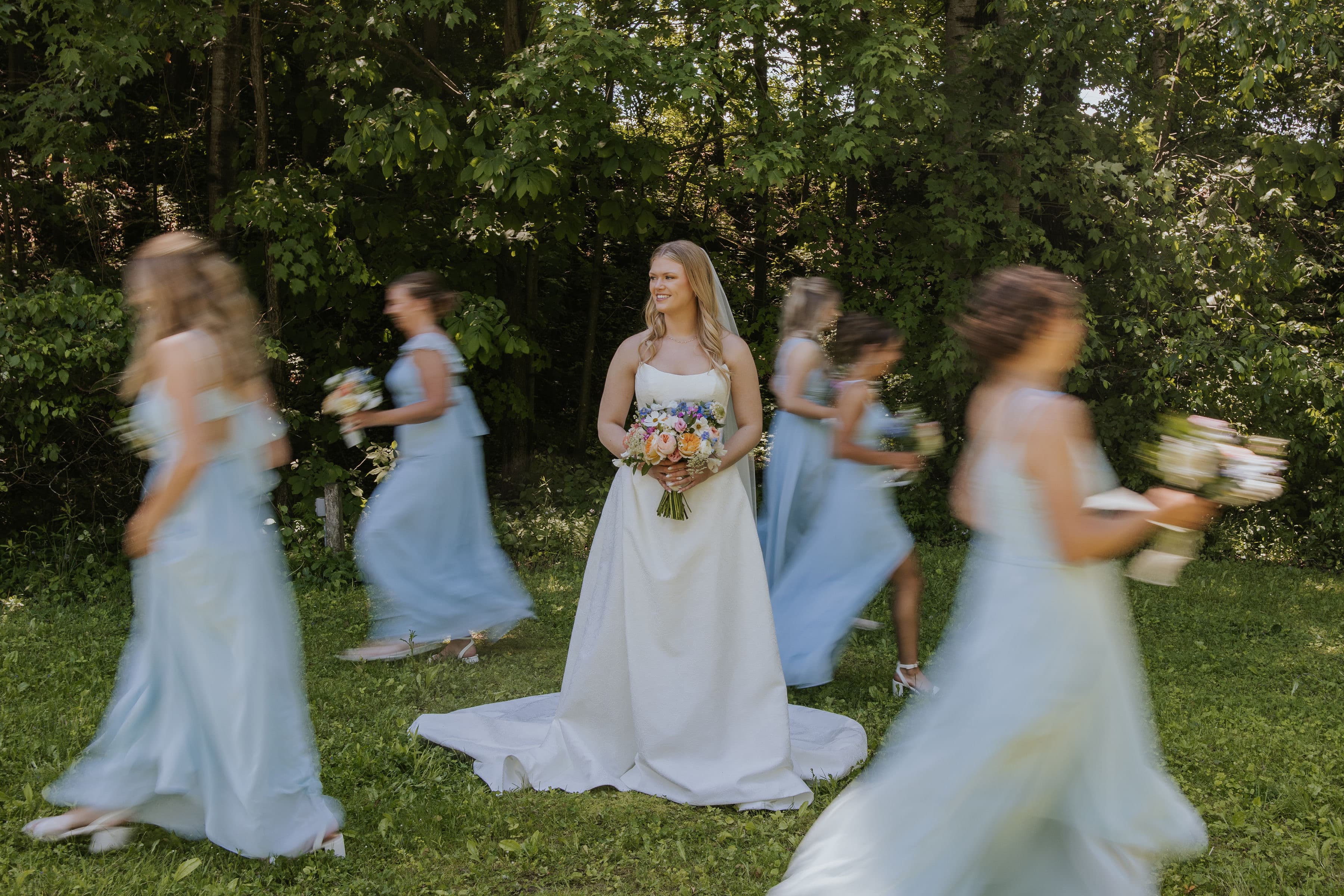 Bridesmaids in dusty blue walking together
